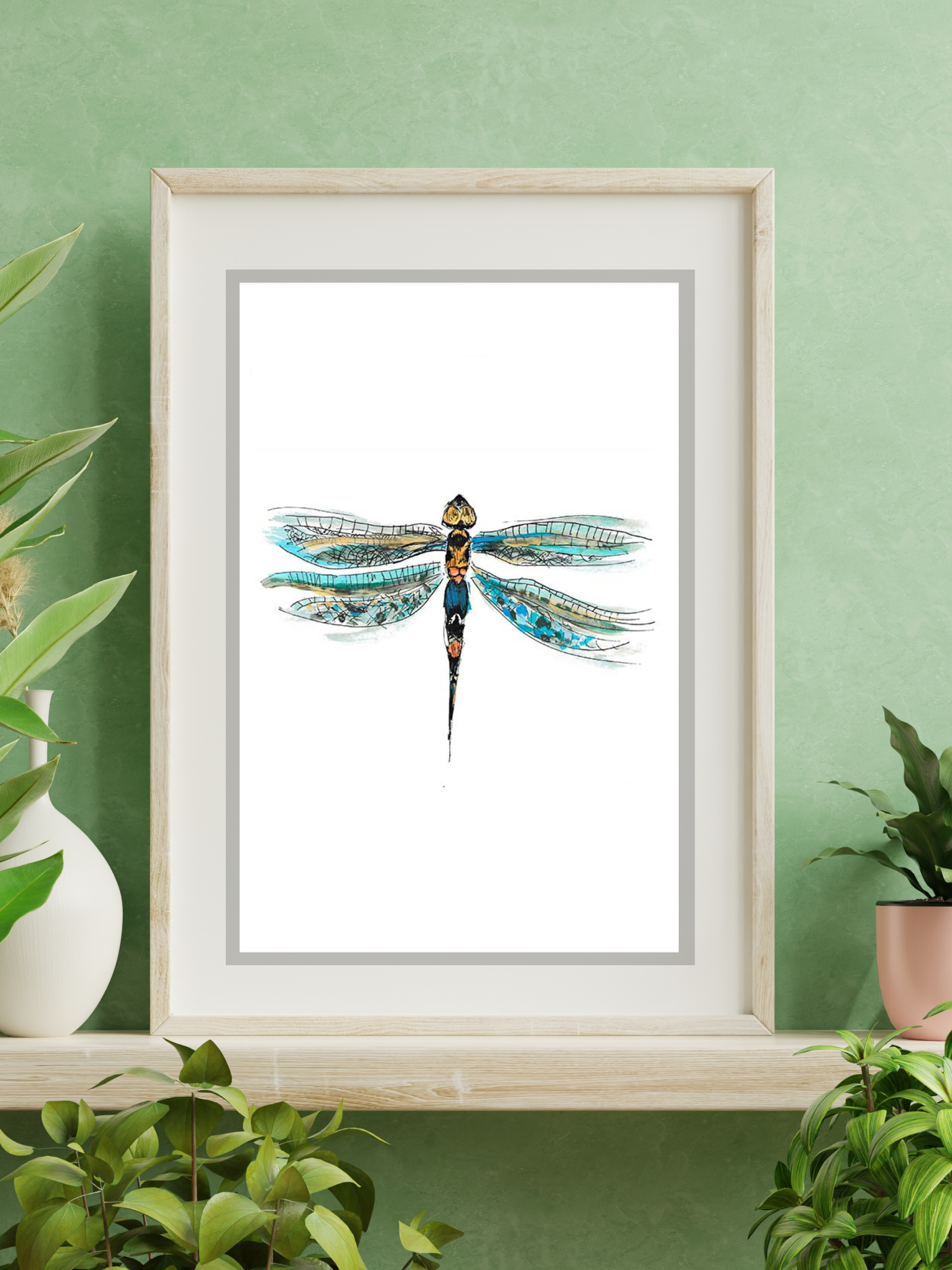 dragonfly art print in frame on green wall