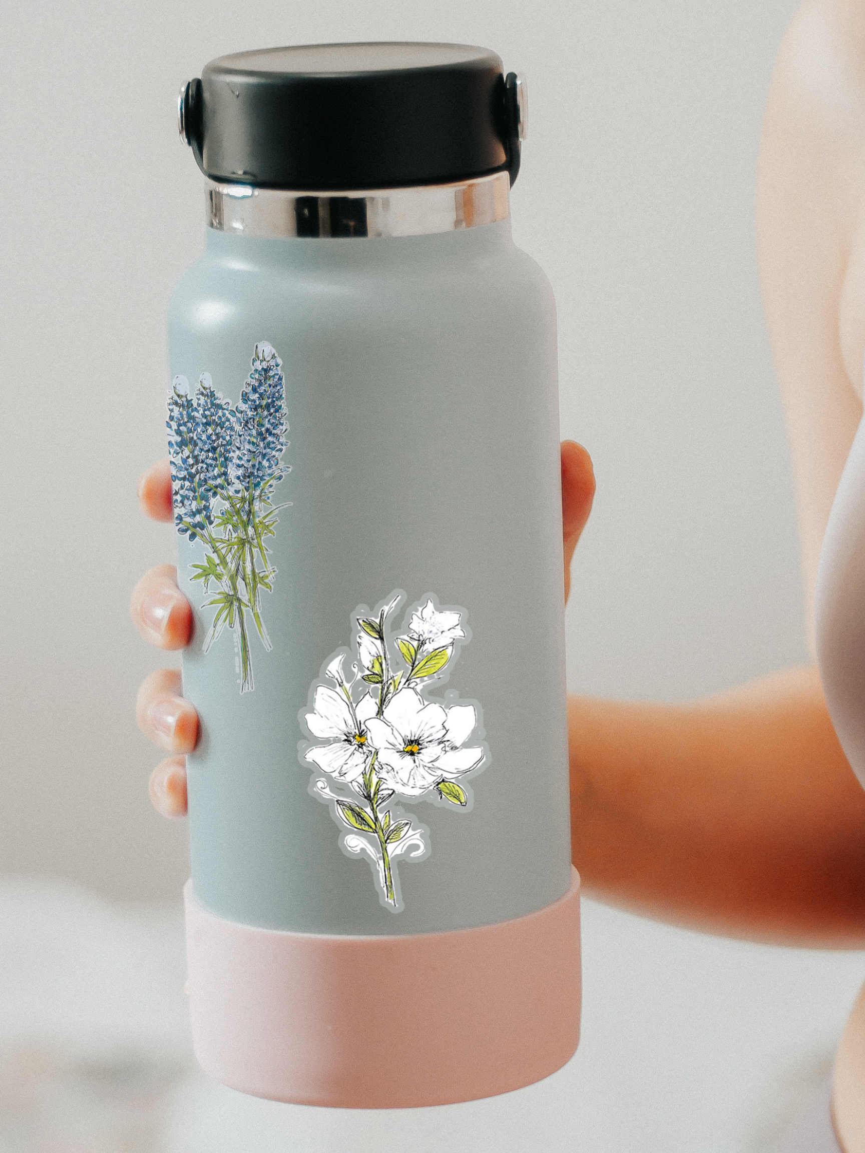 white magnolia flower sticker with clear background on a grey water bottle