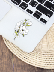 white magnolia flower sticker with clear background stuck on a laptop by the keyboard