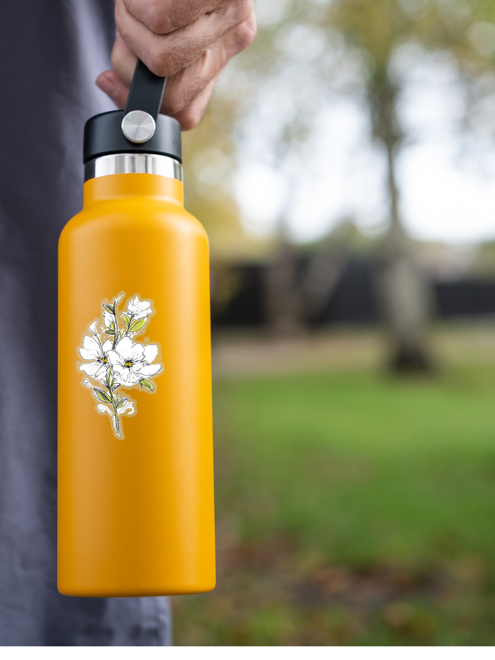 white magnolia flower sticker with clear background stuck on a yellow water bottle