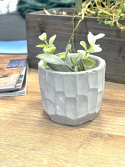 mini concrete planter with plant on coffee table