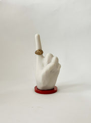 white bonded marble ring holder signaling number one. Situated on a burnt orange base.