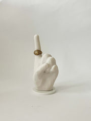 white bonded marble ring holder situated on a white base, signaling number one.